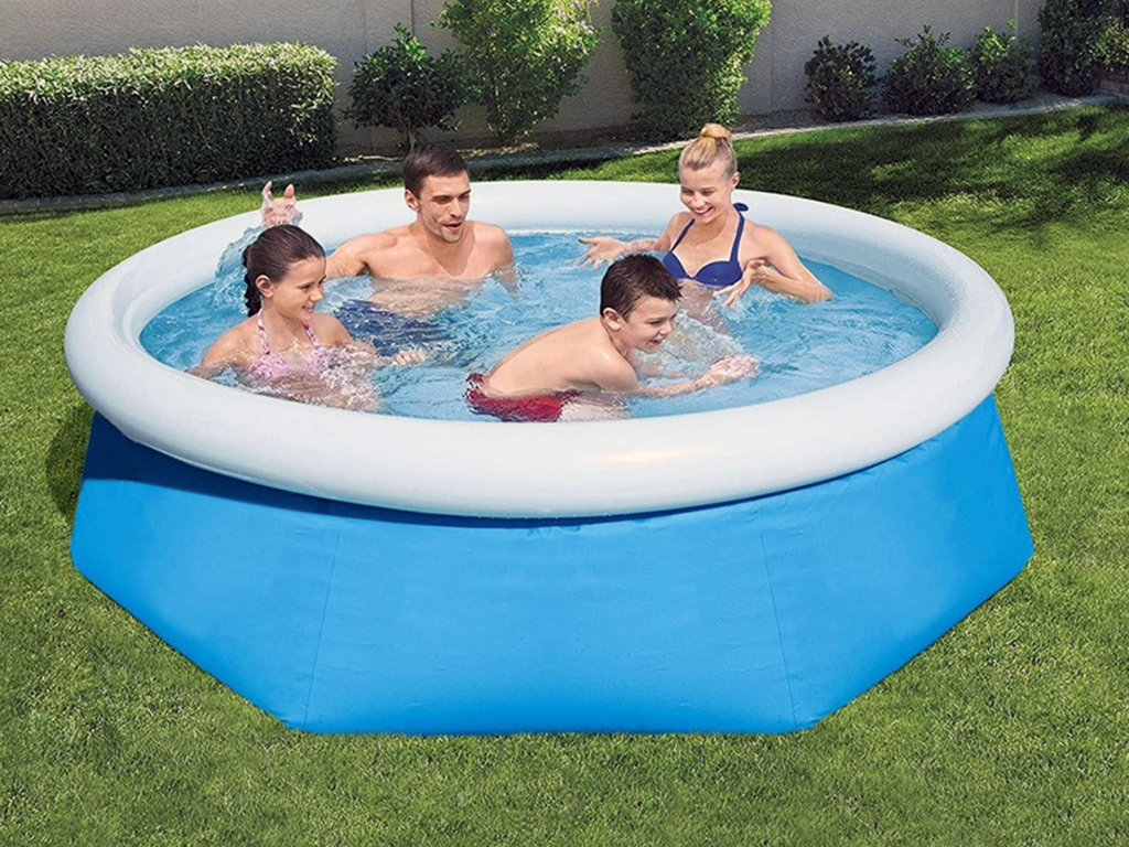 family enjoying an inflatable swimming pool in their backyard