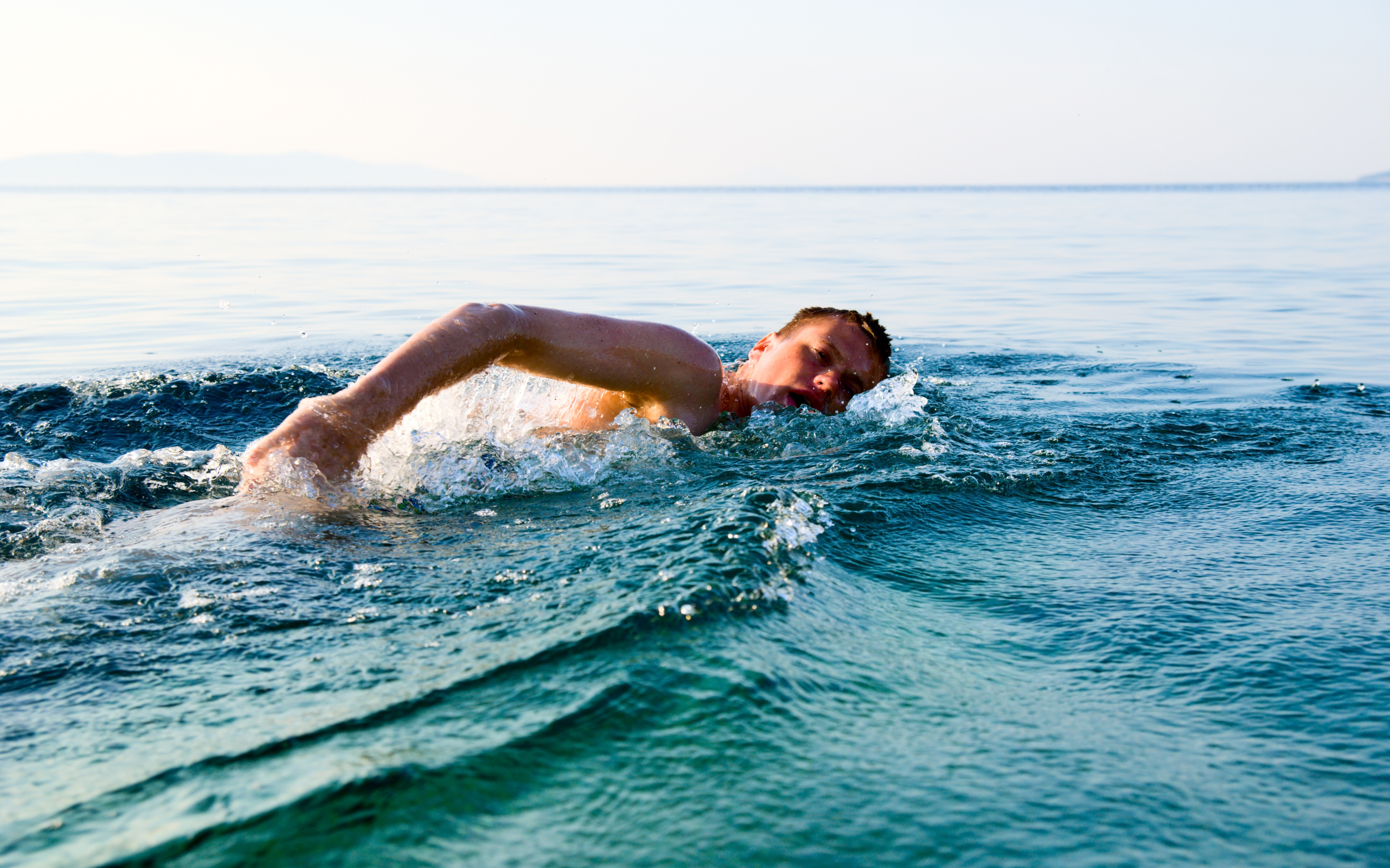 man swimming in open water