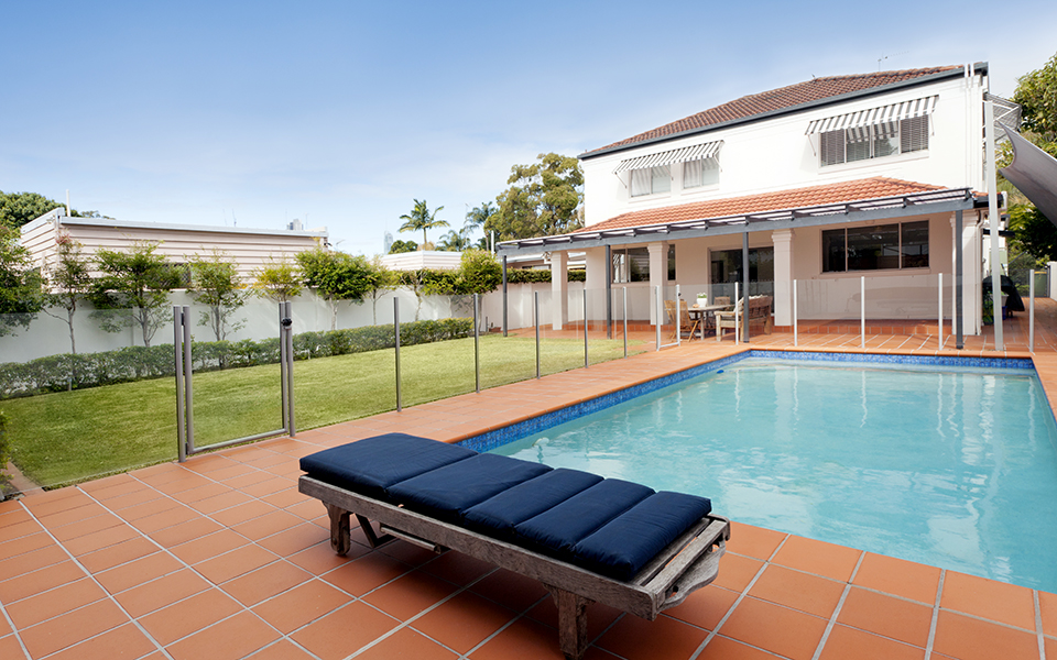 inground pool surrounded by safety fence