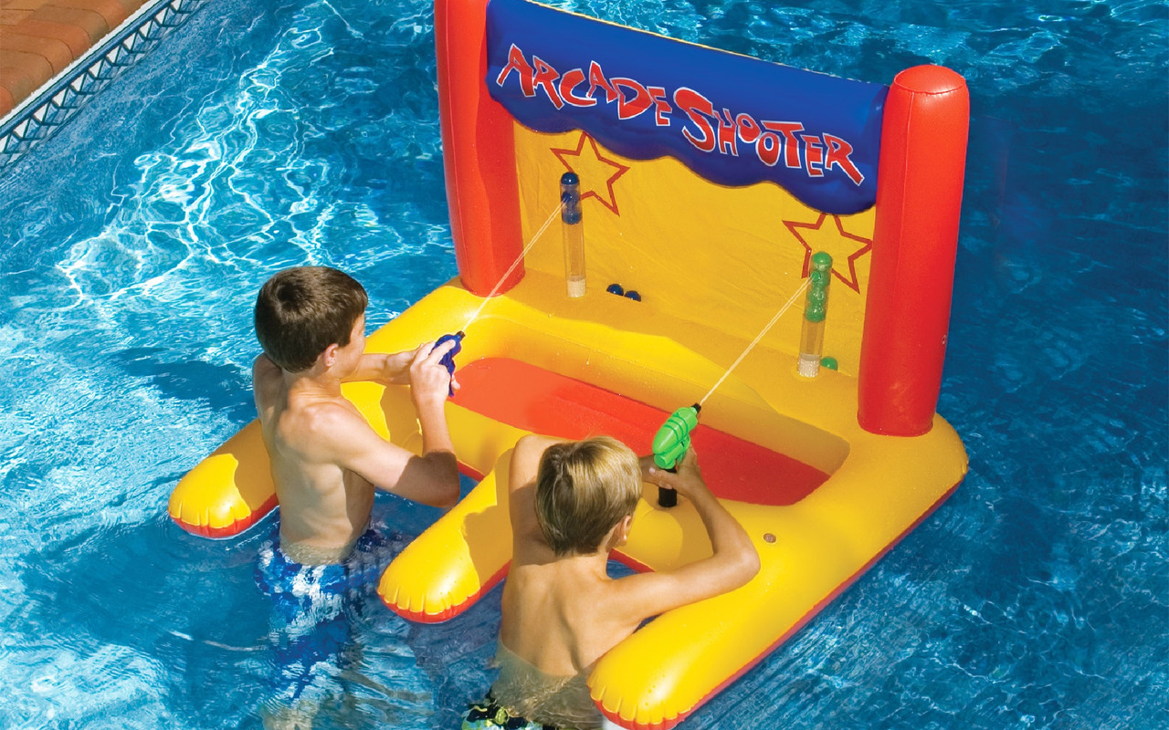 two young boys competing at water arcade